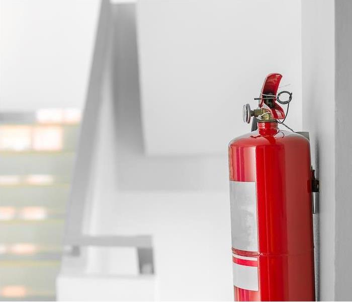 < img src =”safety.jpg” alt = “a fire extinguisher hanging on a wall near a set of stairs" >