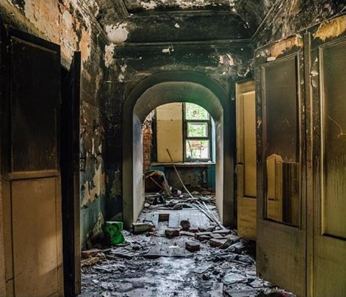 interior view of heavily fire damaged hallway of home